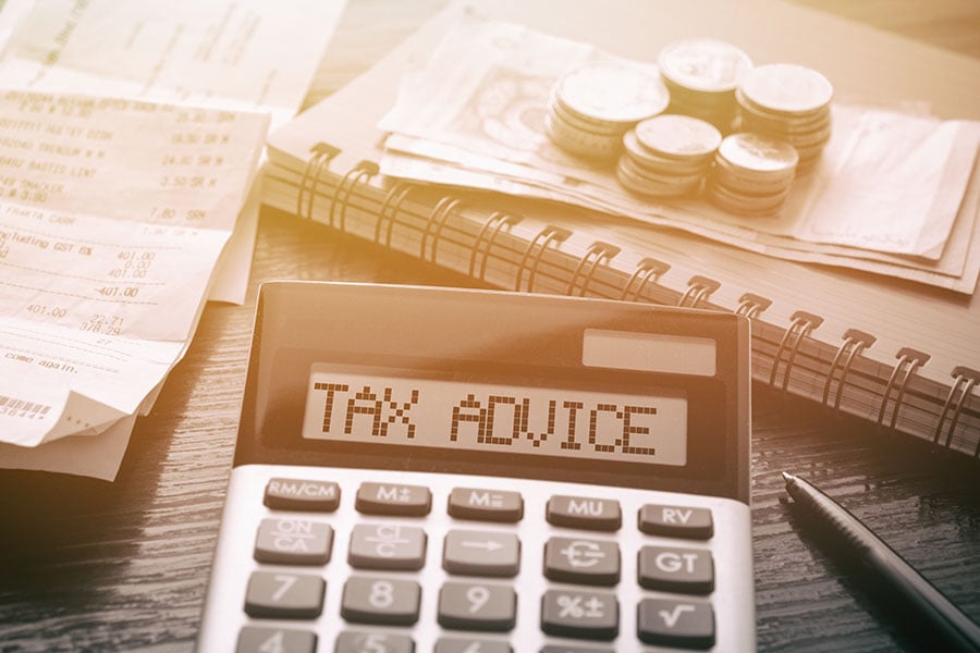 A calculator with the words 'tax advice' written on it