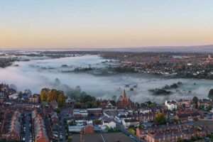 An aerial view of houses in Chester, some under fog