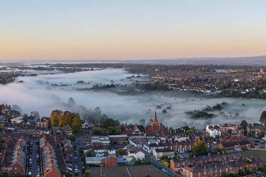 An aerial view of houses in Chester, some under fog