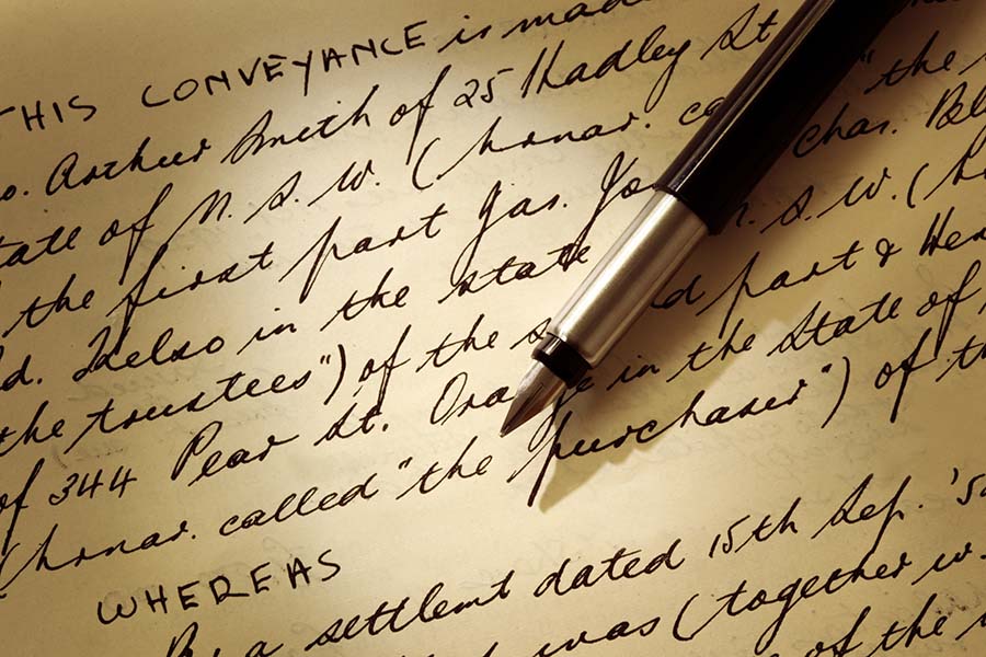 An old-fashioned conveyancing deed with a fountain pen