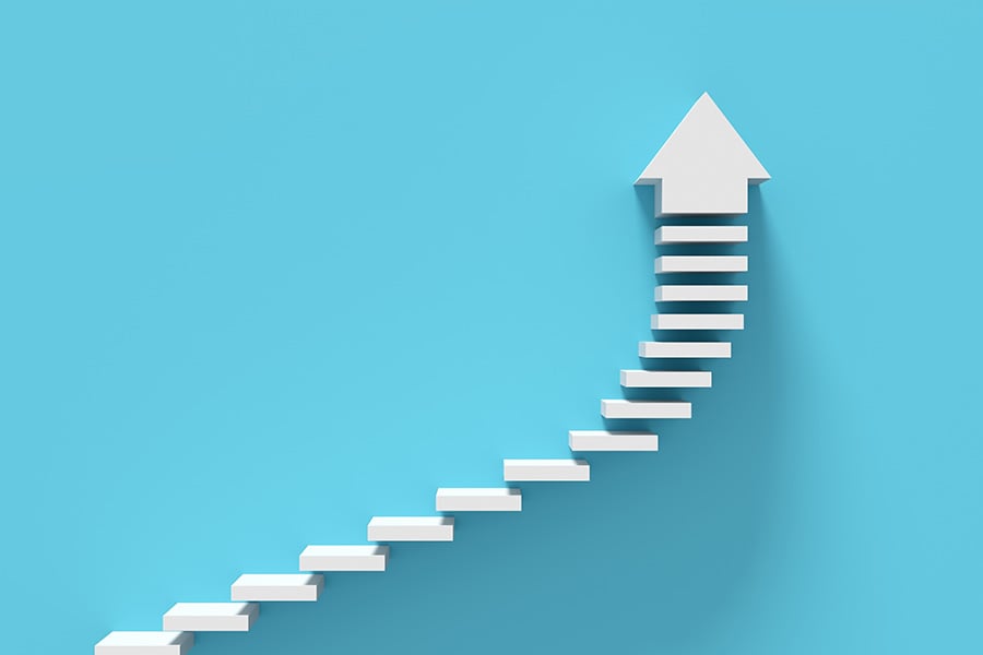 A graphic shows a series of steps on an upwards trajectory with an arrow at the top pointing upwards