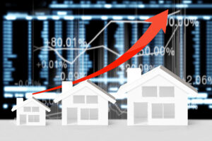 A graphic of three white houses in front of a financial graph, with a red arrow pointing upwards