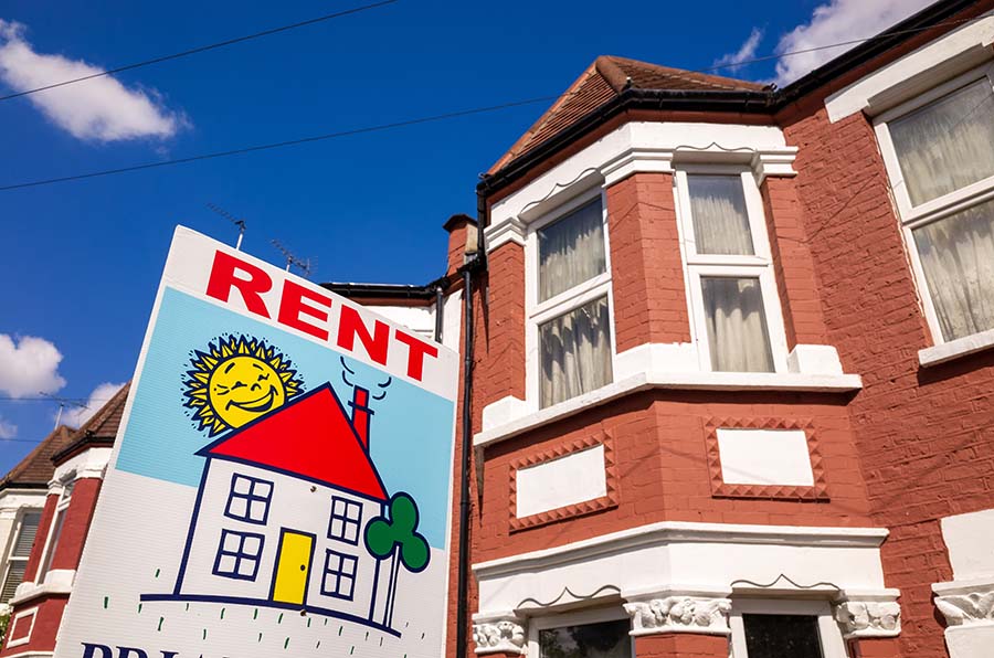 A colourful 'to rent' sign outside a terraced house in England