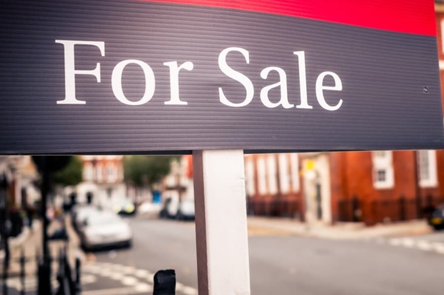 For sale board outside a block of red brick flats