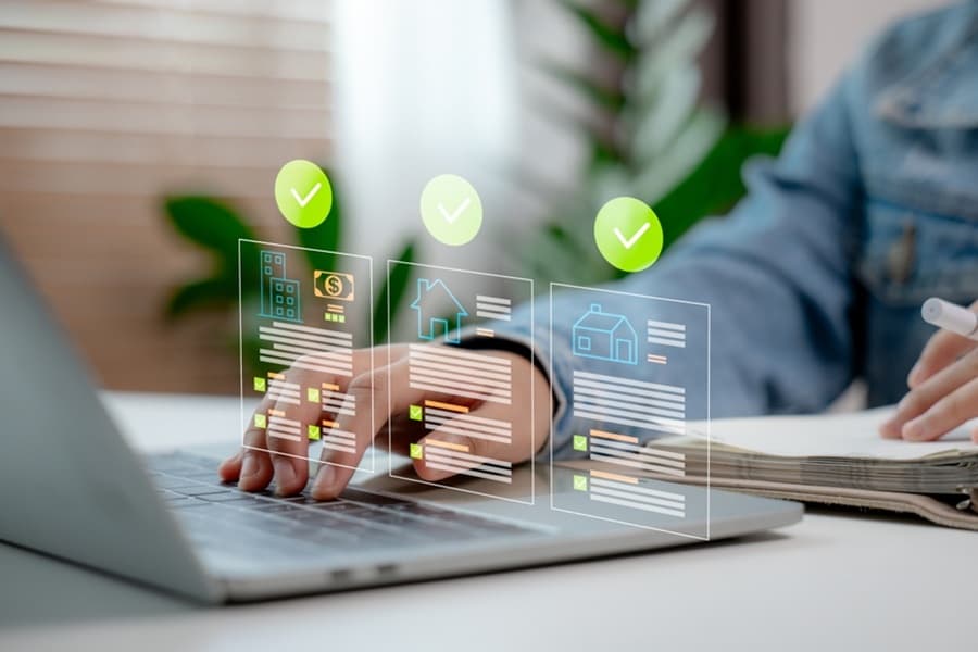 man with laptop and smart pen looking at property data