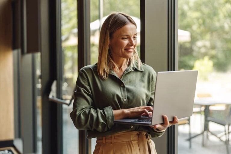 smiling woman working at her laptop