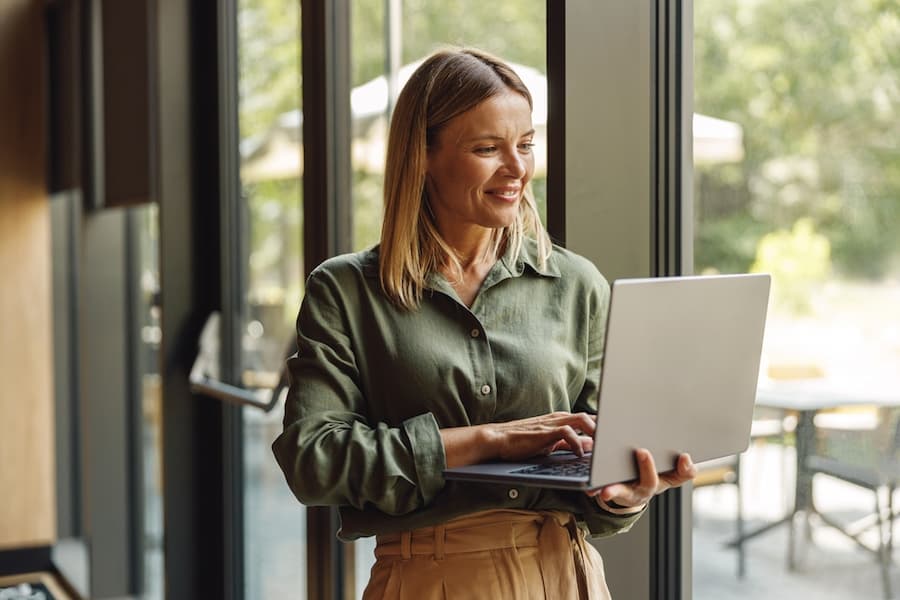 smiling woman working at her laptop