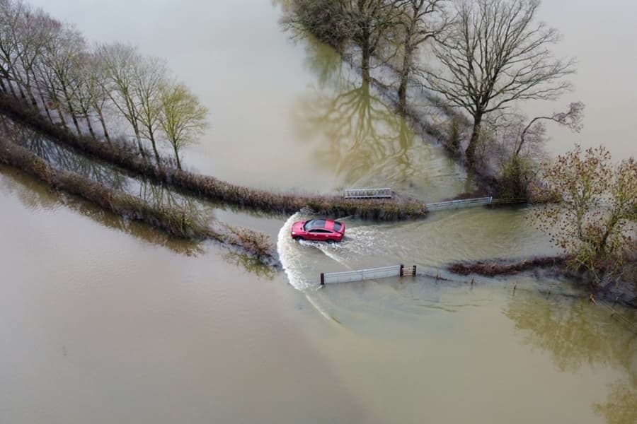 A car driving through a flooded road in England