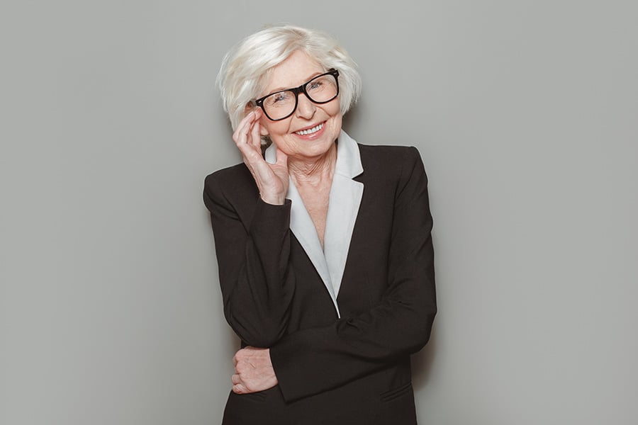 An older professional woman in a black suit
