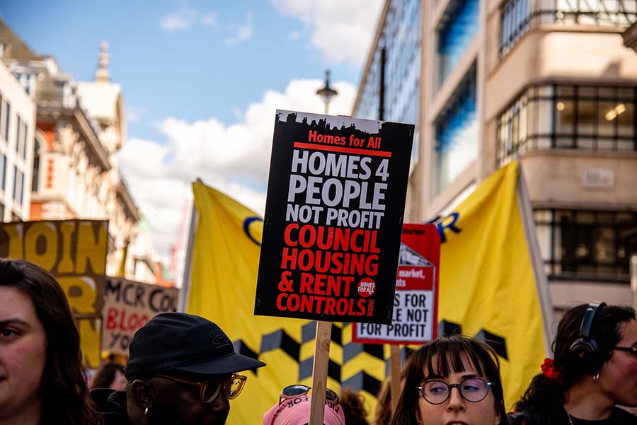 Protesters in London holding signs calling for more social housing