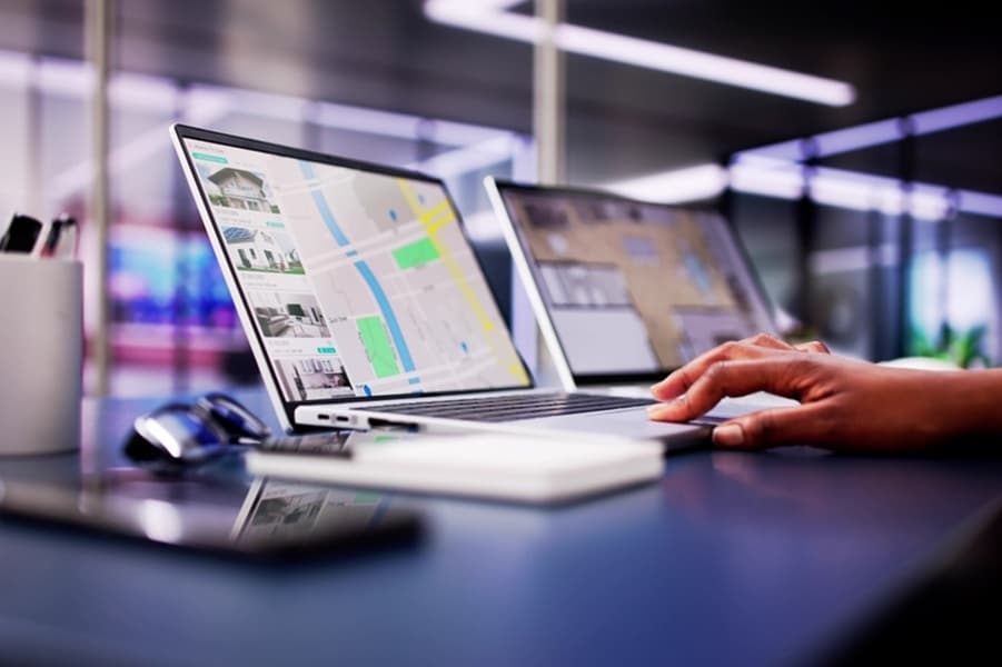 African woman using laptop to search online real estate property listings