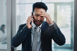 Business man, headache and phone call with stress, confused or worried