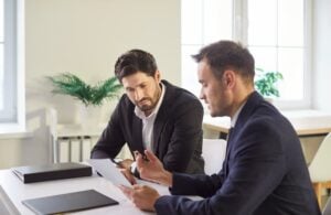 Serious lawyer, solicitor or barrister, supervisor talk to analyse financial report