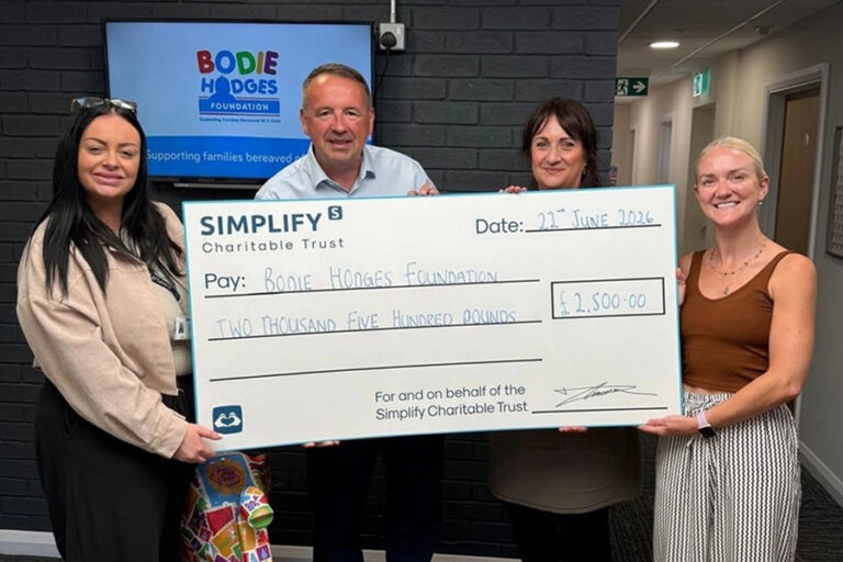 The team at Simplify holding a giant cheque