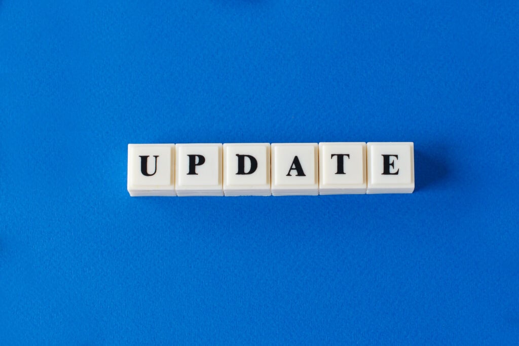 white scrabble pieces on a blue blackground spelling updates