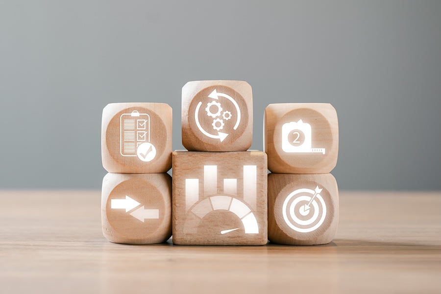 Wooden blocks displaying icons depicting success measurement