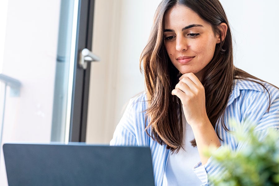 Smiling woman using a laptop