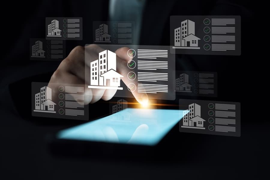 A close-up view of a hand interacting with a smartphone screen displaying a virtual property management interface