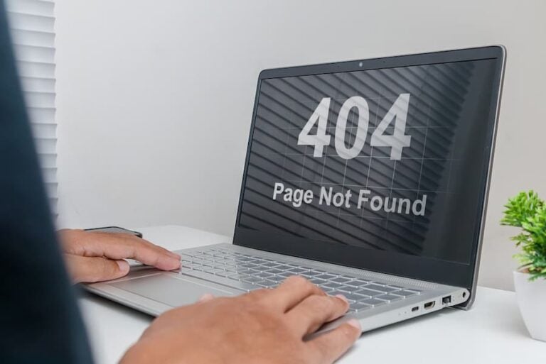 A man working on a laptop with website Page Not Found Error 404 on screen