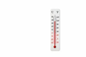 White celsius and fahrenheit scale thermometer isolated on white background. Ambient temperature plus 38 degrees celsius
