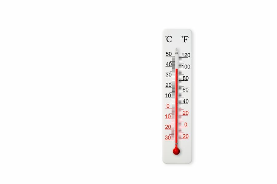 White celsius and fahrenheit scale thermometer isolated on white background. Ambient temperature plus 38 degrees celsius