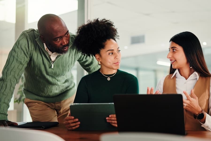 Woman, team and laptop with tablet, office meeting and discussion