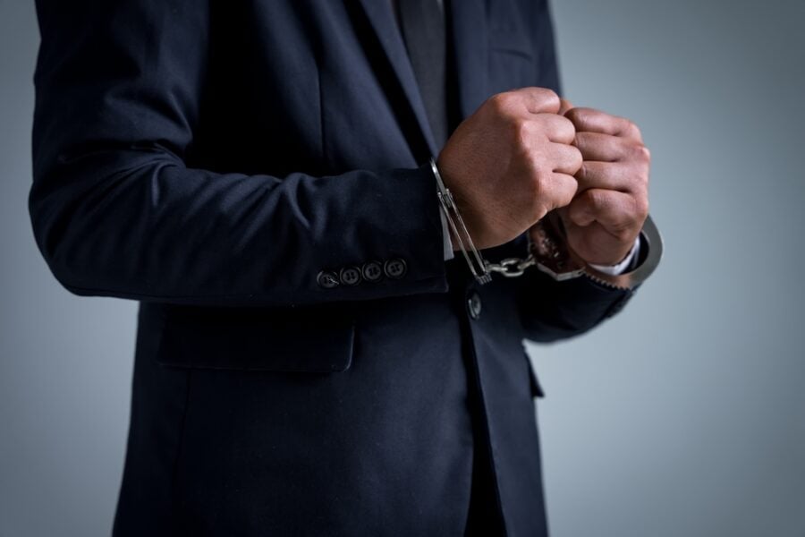 Man in suit and handcuffs
